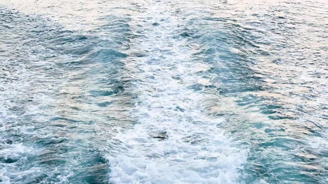 Moving yacht at the ocean with water splashes. Ocean sea water wave reflections. Motor boat in the sea