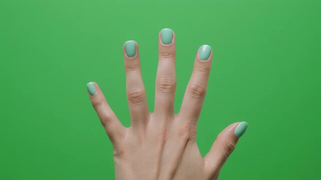 Human hand gesturing counting with fingers on a green screen background with clean studio lighting