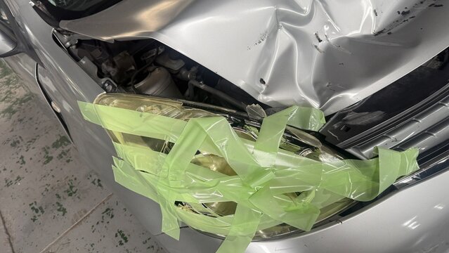 Front-end collision damage with disassembled engine compartment