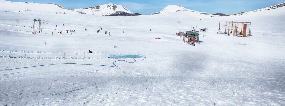 Ski resort with chairlifts and skiers, Campocatino, Italy
