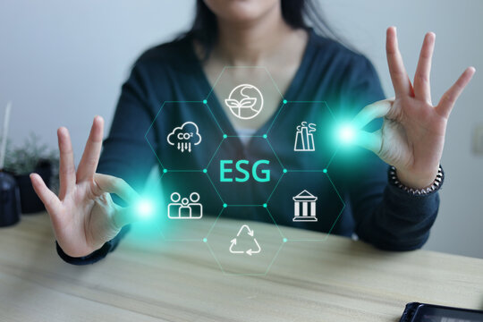 Hand Gestures Displaying Environmental Social Governance Virtual Interface at Wooden Desk