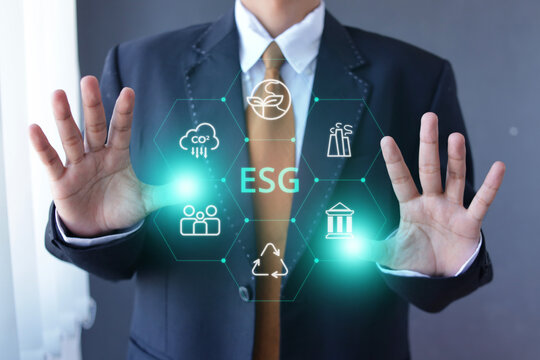 Businessman Raising Both Palms Open Around ESG Hologram Inside Office Room