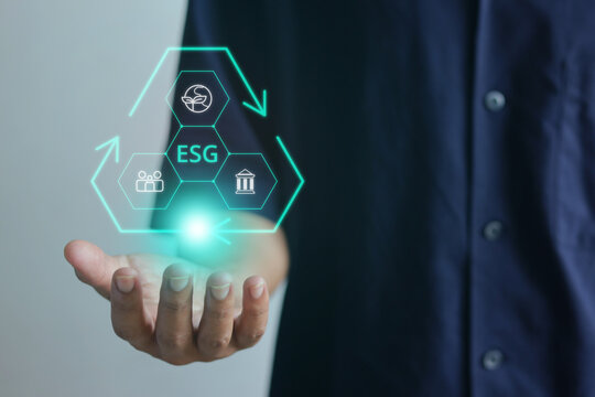 Close Up Person Holding Triangle ESG Hologram over his Open Hand