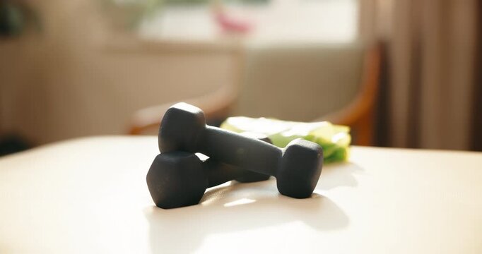 Dumbbells, table and fitness equipment in home for exercise, workout or training gear. Empty, power or iron weights with sport tools or space for weightlifting, strength or physical activity in house