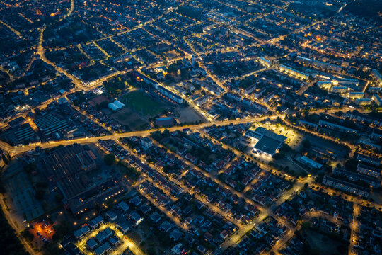Aerial view of the illuminated Parc Expo Mulhouse and surrounding residential streets at night in Mulhouse, Grand Est, France.