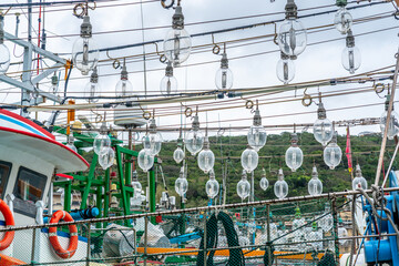 Fototapeta premium Close-up view of fishing boats equipped with fishing light attractor using light bulbs to attract fish in Taiwan