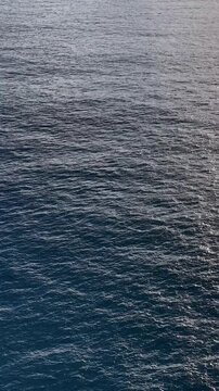 Aerial View of Sparkling Blue Ocean Water with Sun Glare
