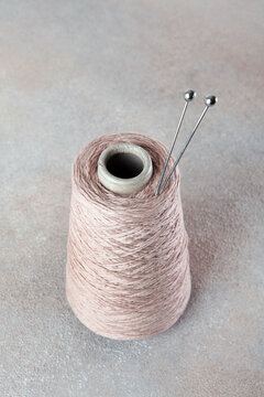 Wool yarn for knitting or crocheting. Yarn on a spool. Fine, pure wool yarn in a fine, light color. Hobby and craft concept