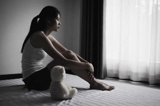 Sad woman sitting alone. Mental health awareness, depression support, domestic conflict awareness, women's safety, hope, recovery, dignity, resilience, and compassion.