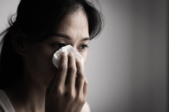 Woman wiping away tears, expressing emotional pain and hope for healing. Mental health awareness, depression support, women's well-being, resilience, compassion, recovery, and emotional care.