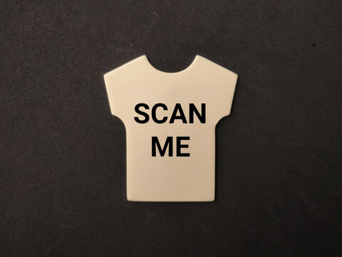 A shirt-shaped cutout bearing the text SCAN ME centered on a dark textured background