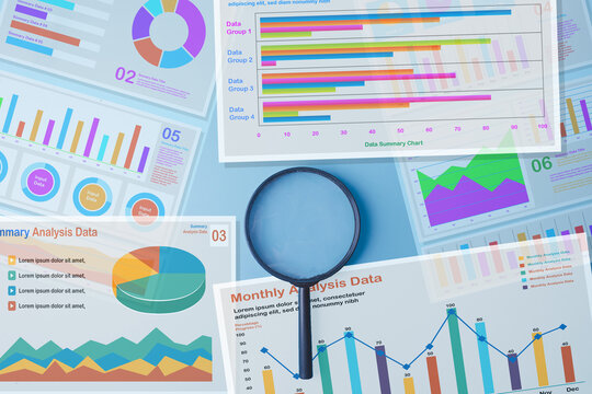Data analysis and financial audit concept. Magnifying glass surrounded by colorful business charts, graphs, and monthly analysis data reports on a light blue background.