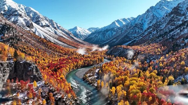 Aerial view of winding river in autumn mountain valley.