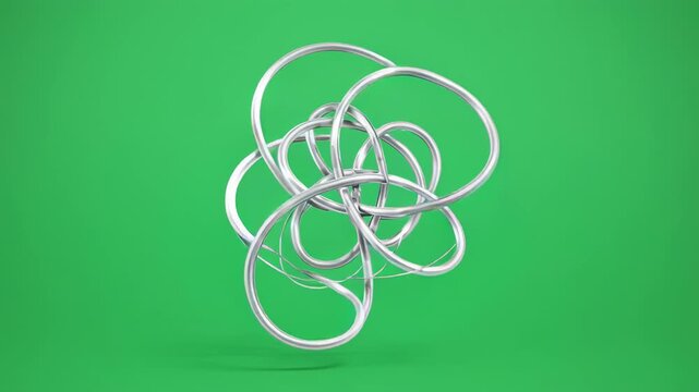 Silver Wire Sculpture slowly rotating on a green cyclorama with soft studio lighting