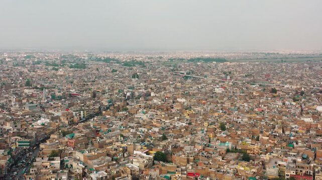 Panoramic overhead aerial view showing crowded residential neighborhood infrastructure with detailed rooftop water tanks, satellite dishes, and buildings.
