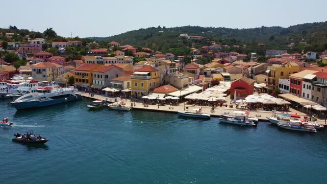 Aerial sweep over the vibrant Gaios harbor in peak summer, Ionian island of Paxos, Greece