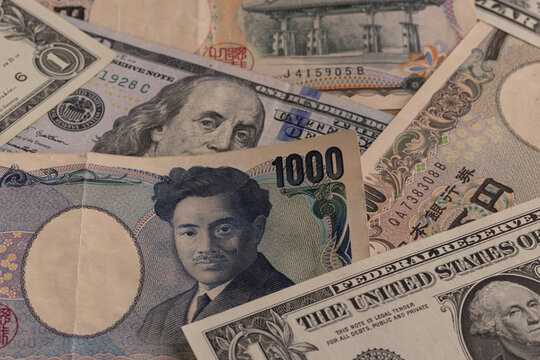 Macro detail of Japanese 1000 and 10000 yen bills mixed with US 100 dollar banknote