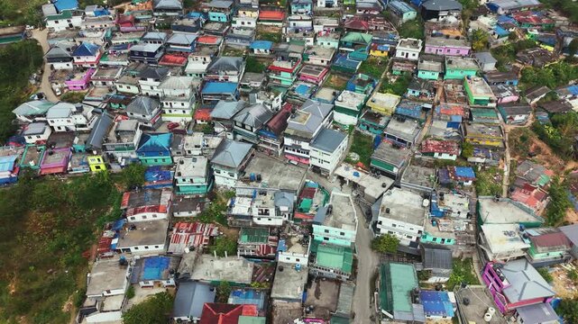 High angle drone shot of Munnar hill station town from above, cloudy day in Kerala