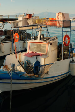 Small fishing boat moored with gear at coastal dock