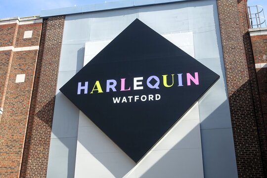 An impressive black diamond-shaped sign representing Harlequin Watford, a prominent shopping destination found in the heart of Watford, Hertfordshire