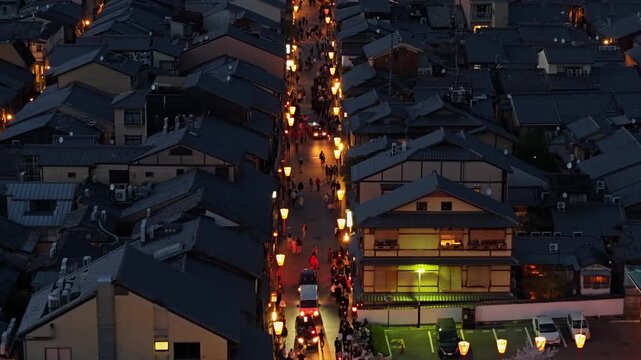 Aerial view of Gion district at twilight in Kyoto Japan with traditional Machiya houses and glowing lanterns.