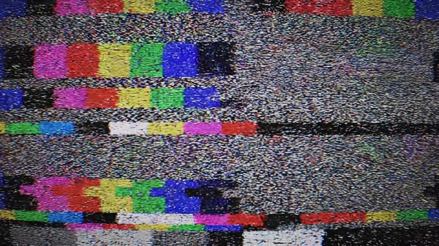 Television test pattern signals with analog static and color bars breaking up on a black background