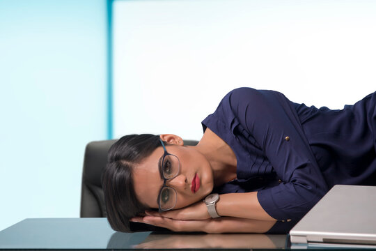 Businesswoman sleeping at desk in office