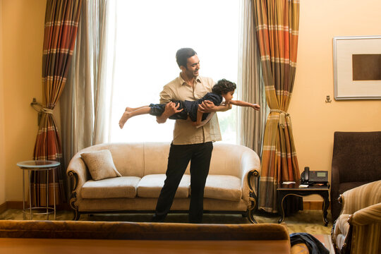 Father holding son like a plane