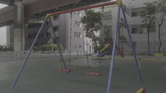 empty swing in the city playground