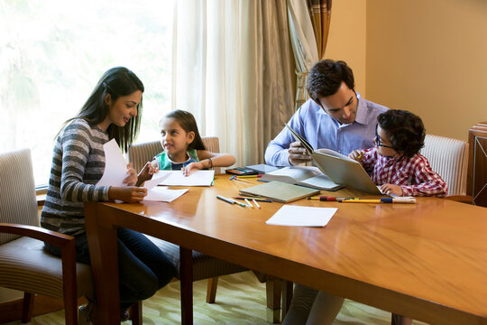 Parents helping daughters with homework