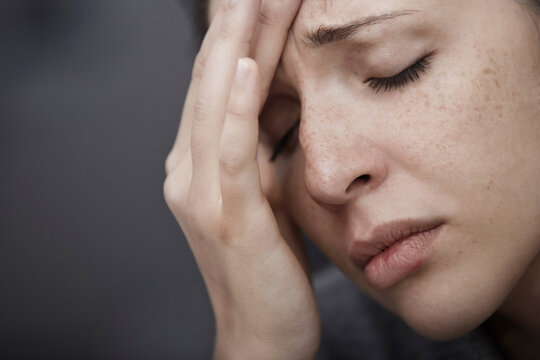 Sad woman suffering from headache