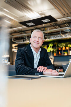Thoughtful businessman plans success at his modern office desk