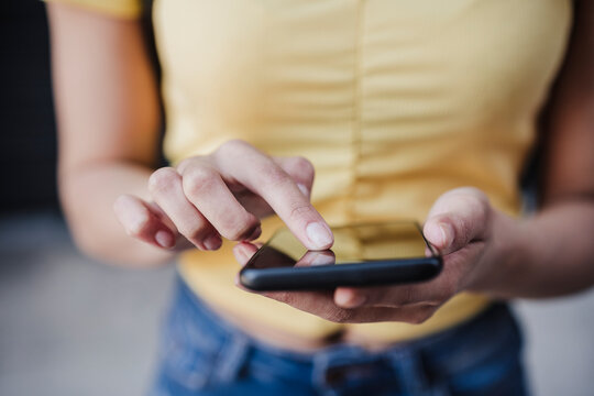 Woman touching screen of smart phone