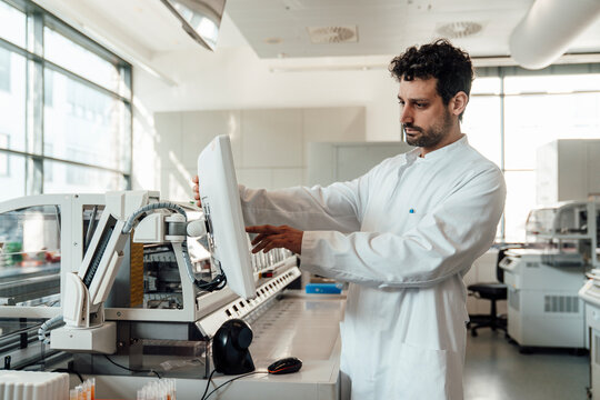 Scientist analyzing information on monitor in laboratory