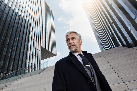 Portrait of fashionable businessman in front of modern architecture