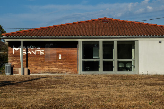 Modern exterior facade of a rural community health center building with wooden cladding