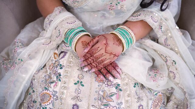 Indian bride with henna hands. Traditional wedding mehndi design on woman in Mumbai, India.