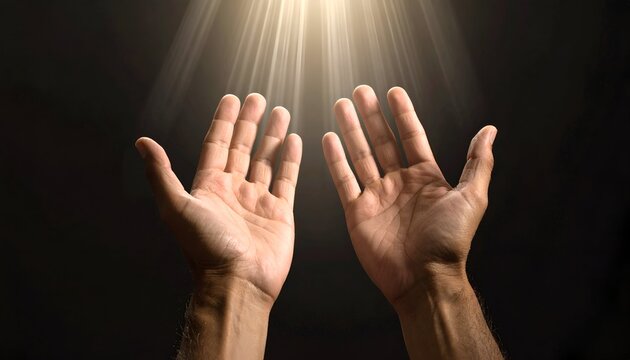 Two outstretched hands upward in a shaft of light against a dark background