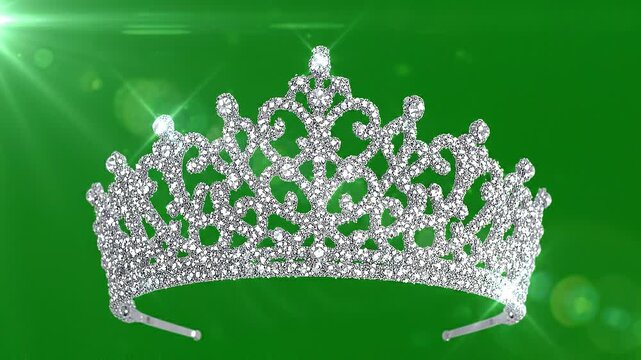 Sparkling silver glitter tiara crown with rhinestones on green bokeh background