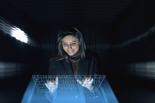 Smiling Businesswoman using virtual keyboard
