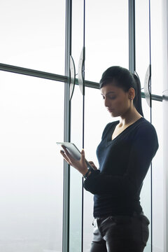 Young woman using digital tablet in modern office
