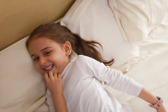 Portrait of girl lying in bed