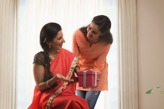 Daughter giving mother birthday gift