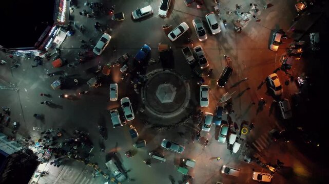 Top Down Drone View of Fawara Chowk Rawalpindi at Night With Moving Vehicles, City Lights and Busy Streets