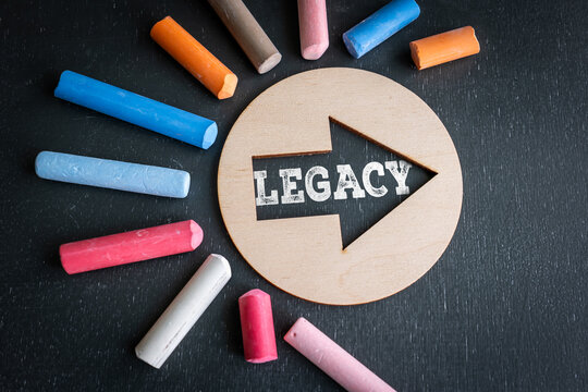 LEGACY Concept with Wooden Arrow and Colorful Chalk on Blackboard