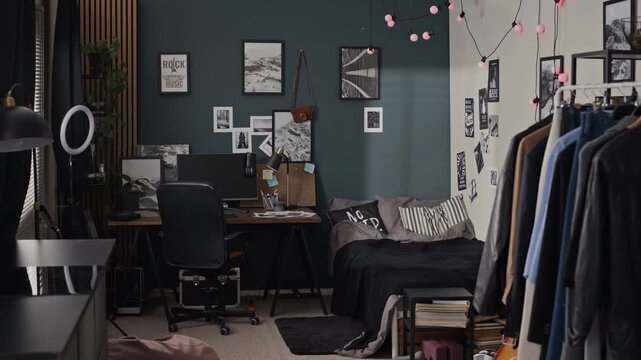 Camera panning across modern bedroom showing desk with computer, ring light, and bed. Video is ideal for youth lifestyle commercials, remote work, or student housing advertisements