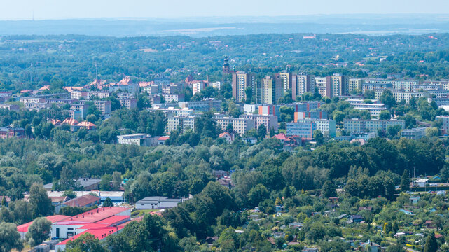 European city aerial view with modern residential blocks among lush green trees