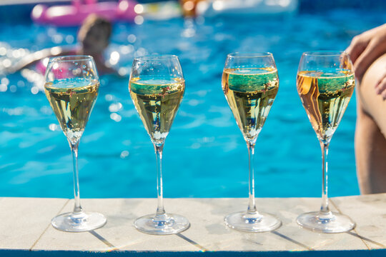 Champagne by the pool. Selective focus.