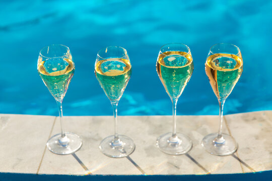 Champagne by the pool. Selective focus.