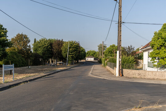Asphalt road and street view with direction signs in the village of Septfonds, Tarn-et-Garonne, France